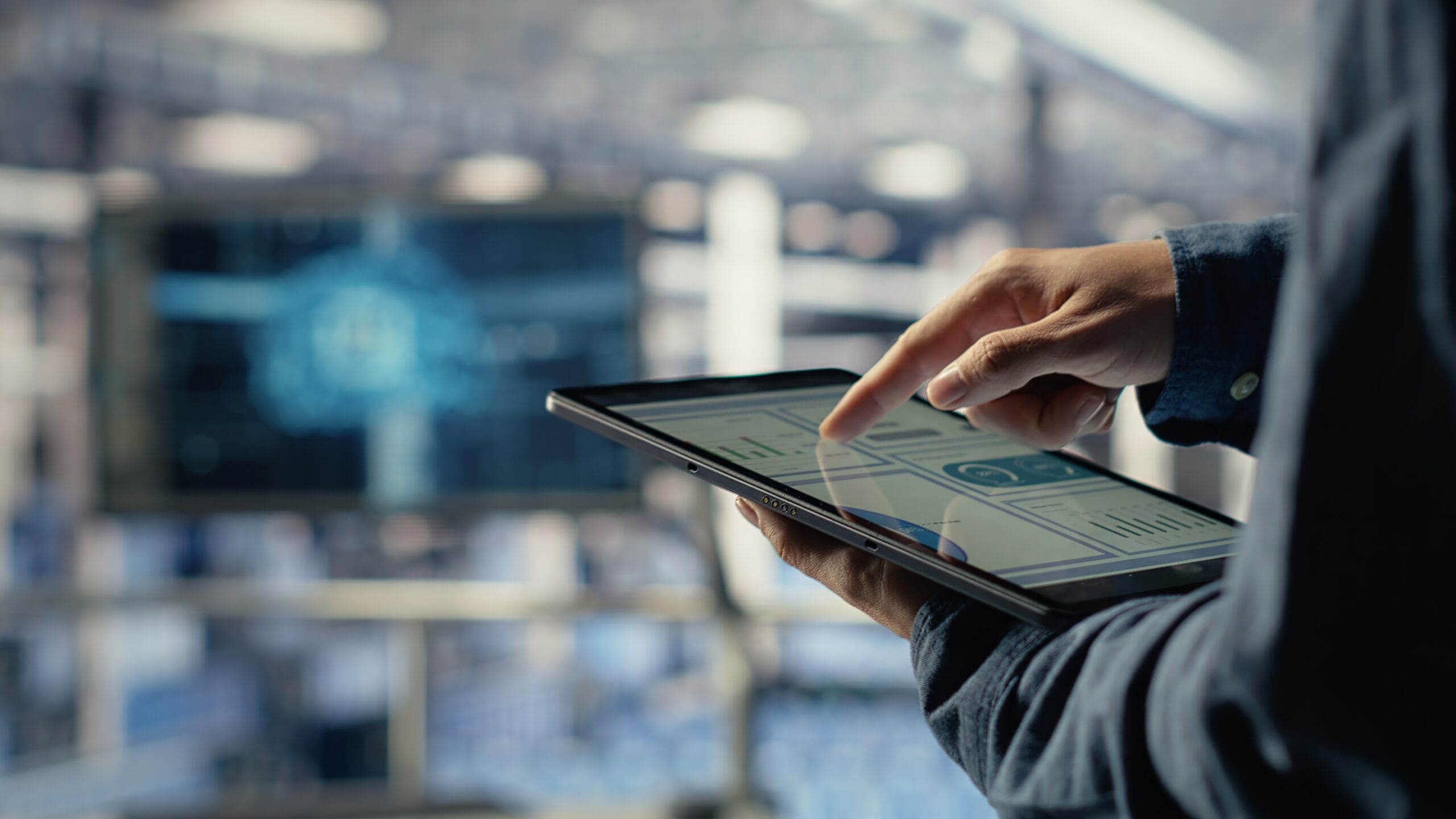 Professional using a tablet in a modern technology-driven office environment