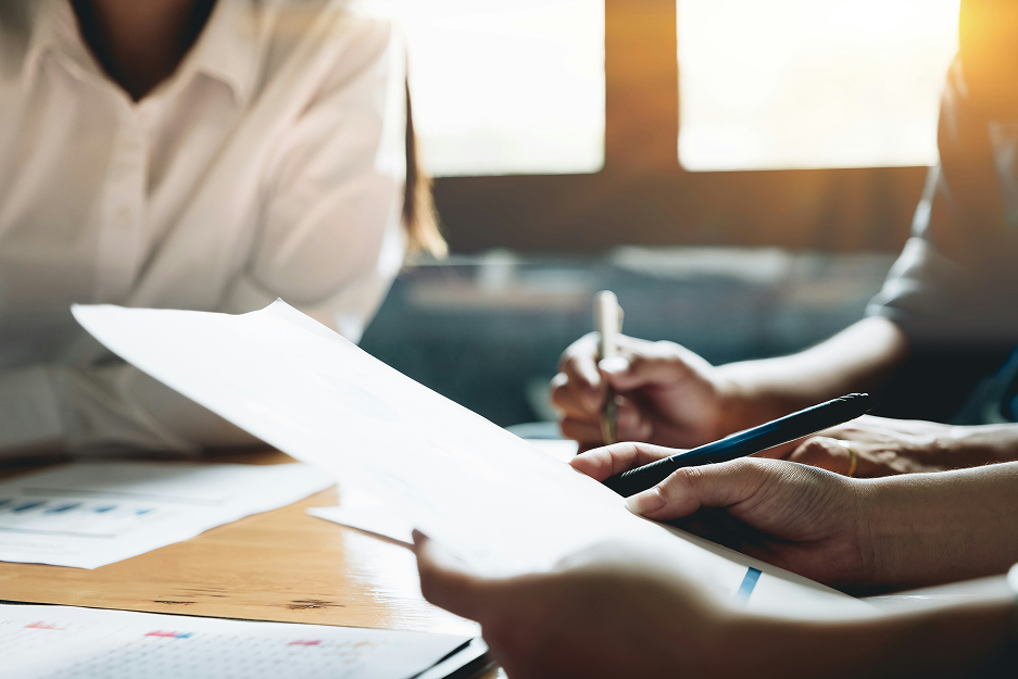 Professionals reviewing legal documents at a desk